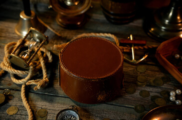 Treasure island concept on a wooden table background. Round banner on sailor or pirate table between different marine atributes