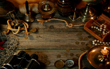 Treasure island concept on a wooden table background. Frame from vintage marine objects around...