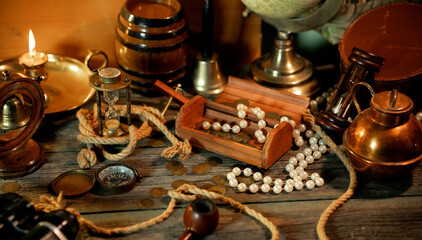 Sea concept on a wooden table background. Chest with treasure on pirat table