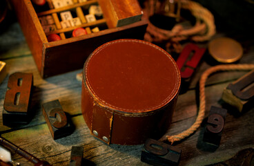 Vintge round box for text, logo on wooden table. Retro type objects and old wooden typographic...