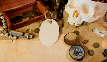 Treasure island theme. Vintge oval label on the sand among shells, stones and marine elments. Frame...