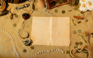 Treasure island theme. Vintge sheet of paper on the sand among shells, stones and marine elments....