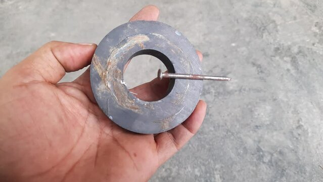 The circular speaker magnet attracts metal objects,
