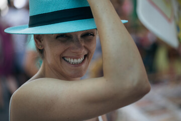 Young women, enjoying life. Big Smile, trying on a hat, holidays.
