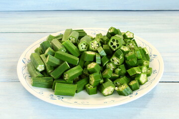 garden fresh chopped cut green Lady Fingers or Okra vegetable in plate ready for cooking top view     