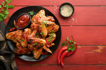 Chicken wings. Grilled or baked chicken wings with sesame seeds and ketchup or spicy tomato sauce...