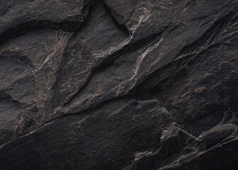 A mysterious dark natural stone texture background with a subtle, textured surface.