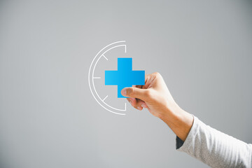 Isolated, a male hand holds a plus icon, embodying positivity, benefits, development, health insurance, growth. This speaks to innovation in health care and technology, symbolizing an enhanced future.