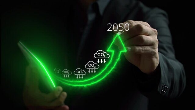 Businessman holding tablet with increasing arrow and carbon reduction for decrease CO2, carbon footprint and credit to limit global warming from climate change. Bio circular green economy concept.