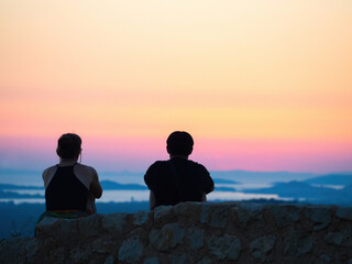 silhouette of a romantic couple watching the sunset