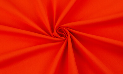 Bright orange fabric folded into a rose