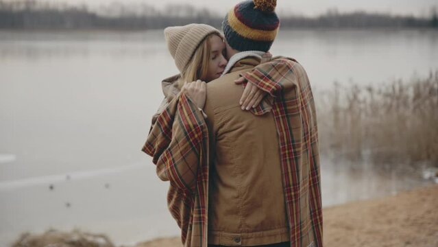 Cheerful smiling couple kissing on nature closeup. Portrait of happy affectionate lovers enjoy romantic date in park. Positive sensual pair feeling love hapiness together. Romance relationship concept