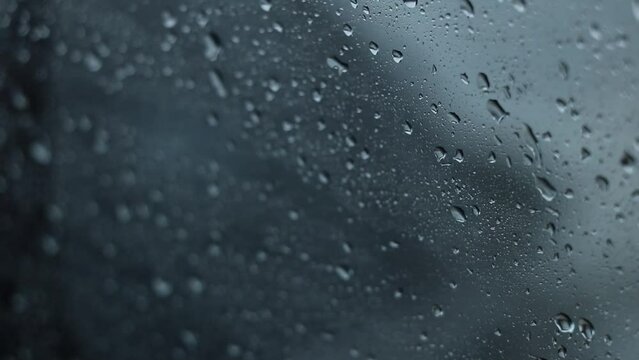 Raindrops on a moving car at speed, view of the windows from the inside, rain on the window, bad weather