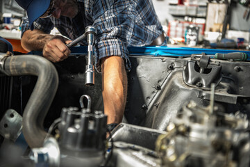 Car Mechanic Repairs Gasoline Engine in His Clients Car