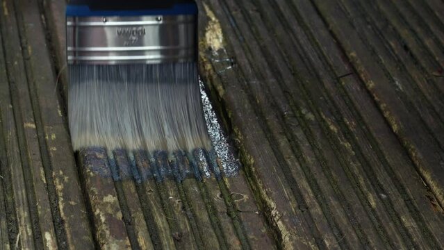 Painting old worn wooden decking with treatment 