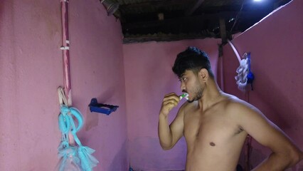 person in the bathroom and brushing teeth