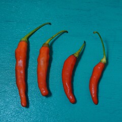 some red chilies on a turquoise wooden board