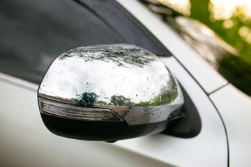 Closeup of the headlight of a modern car in the countryside