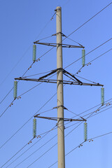 Close up of a transmission tower or power tower on sky background. They are also known as electricity pylon or electric pylons