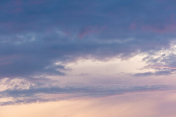 Obraz premium Pink blue clouds at sunset as background