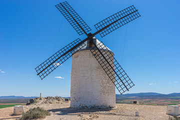 Hilltop windmills, silhouette against the Spanish sky. Toledo's history, culture, and scenic beauty intertwined in one frame