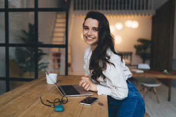 Satisfied woman with laptop having break from work