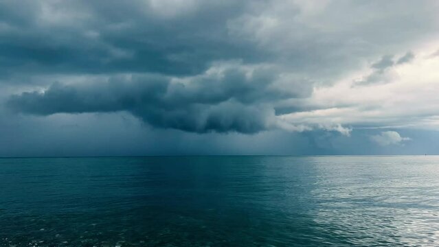 Blue heaped thunderclouds over calm surface of Black Sea. Skyline. Copyspace. Concept of anxiety, calm, worry, peace. Dramatic scene. Wallpaper for desktop, screensaver. Copy space for text. Batumi