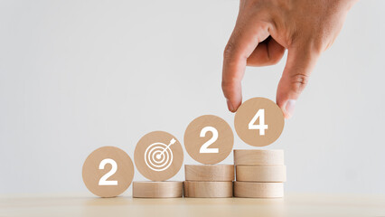 2024 business goals, new start-up planning ideas Wooden cube with year 2024, new project planning...