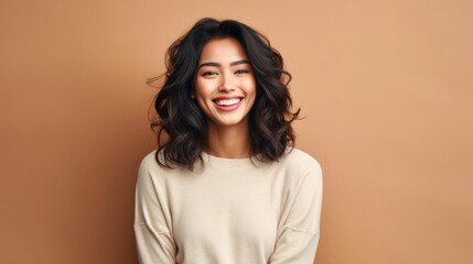 A portrait of pure joy: a teenage girl's radiant smile against a softly lit studio backdrop.