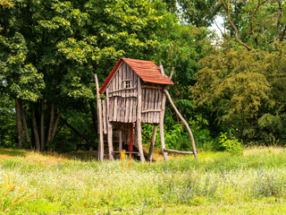 rustic play house on stilts