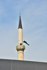 Symbols of Islam on the mosque. Old minaret with Islam flag and copy space for text.