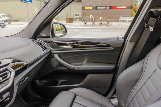 Beautiful View Of BMW IX3 M-sport Leather Car Interior With Passenger Front Seat Parked In Parking Lot Near Shopping Center. Sweden. 