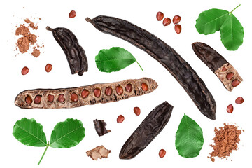 Ripe carob pods and bean isolated on white background with clipping path and full depth of field. Top view. Flat lay - obrazy, fototapety, plakaty