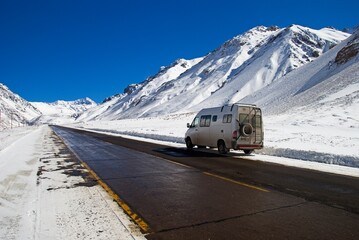 A Camper Van On The Side Of A Road In Parque Provincial Aconcagua In Winter; Mendoza, Argentina - obrazy, fototapety, plakaty