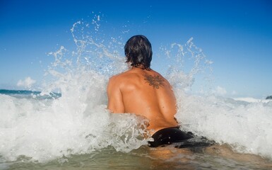 A Man Jumping Into The Waves; Gold Coast, Queensland, Australia