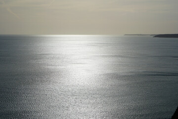 quiet sparkling surface of the ocean with reflecting sunlight 