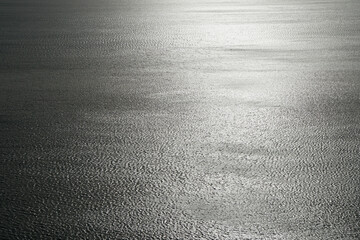 quiet sparkling surface of the ocean with reflecting sunlight 