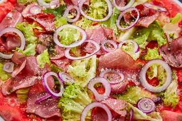 pizza with red onion and bacon