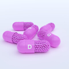 Vitamin D With Pink Capsules, Granules and White Background