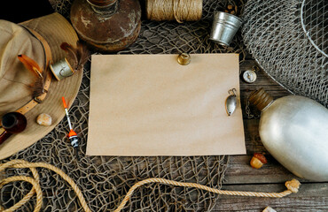 Vintage paper for your text logo. Fishing tackles, cap, net, bucket on a wooden background.	
