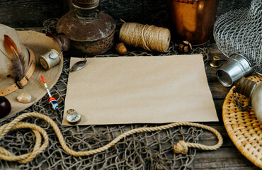 Vintage paper for your text logo. Fishing tackles, cap, net, bucket on a wooden background.