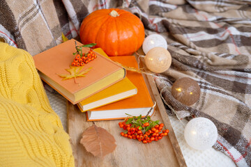 Autumn Decor and Creativity, autumn Yellow Leaves, pumpkin, checkered cozy blanket, balls of garlands, orange pyracantha Berries, books, Lifestyle and Relaxation