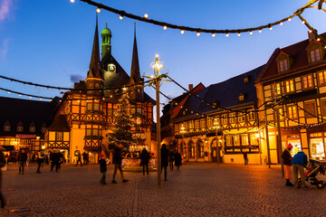 Market square historic city hall Wernigerode in Harz region of Sachsen-Anhalt Land Germany evening night sky. Christmas decoration in old European small scenic town. Scenic Europe travel destination