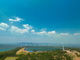 .aerial view white cloud in blue sky above wind turbine on the top of mountain at sunset in Lam...