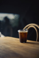 cup of ice americano coffee on table