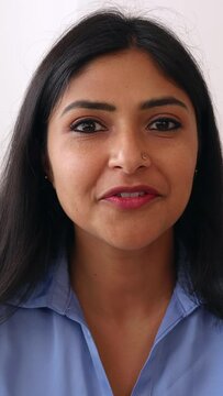 Vertical POV screen view of young indian businesswoman talking with colleague on laptop video call. Head shot of confident professional ethnic female having an online conversation. 
