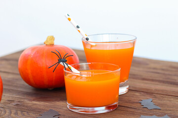 Pumpkin with juice on a wooden table, Halloween concept