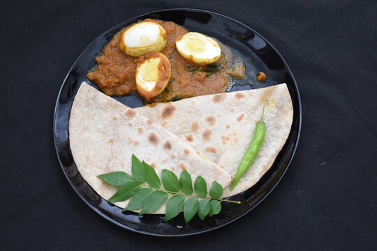 tasty chapathi chapati with egg masala gravy black plate background