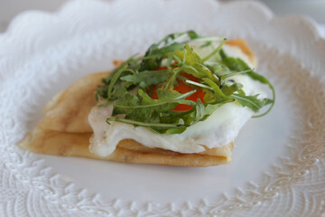 wheat crepes, galette bretonne with egg, green arugula, french brittany cuisine