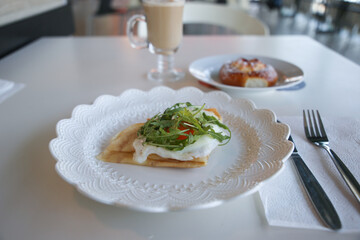 wheat crepes, galette bretonne with egg, green arugula, french brittany cuisine